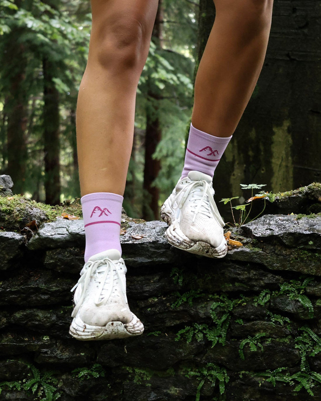 runner wearing purple running socks on a run through woodland